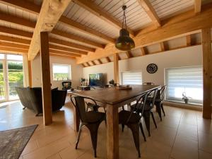 a dining room with a large wooden table and chairs at Ferienhaus Naturregion Sieg bis 6 Personen in Windeck +43 photos