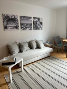 a living room with a white couch and a table at Lorenzo Appartement-01 in Burglengenfeld