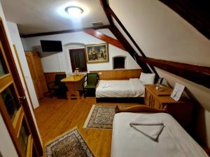 a bedroom with a bed and a desk and a table at Armenopolis - Adults Only in Gherla +52 photos