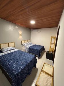 מיטה או מיטות בחדר ב-Essência de Atins