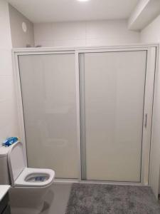 ein Badezimmer mit Toilette und Glasschiebetür in der Unterkunft Appartement de 90 m2 en 1ere ligne face a l'ocean in Vila Praia de Âncora + 19 Fotos