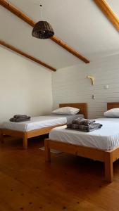 a room with two beds and a ceiling at Kaia Beach House Boa Vista Front Sea View Apartments in Sal Rei