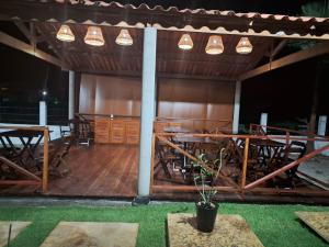 a group of tables and chairs in a pavilion at Essência de Atins in Atins +15 photos
