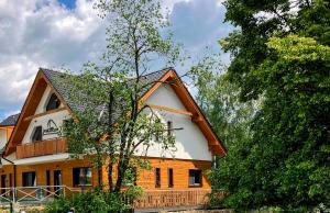 a house with a gambrel roof on top of it at Vila DEDO in Vysoke Tatry - Tatranska Lomnica.