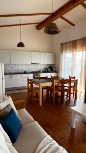 a kitchen and living room with a table and chairs at Kaia Beach House Boa Vista Front Sea View Apartments in Sal Rei