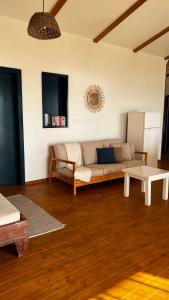 a living room with a couch and a table at Kaia Beach House Boa Vista Front Sea View Apartments in Sal Rei