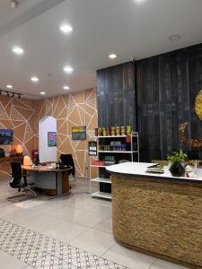 a store lobby with a counter and tables and chairs at S8 Boutique Hotel near KLIA 1 & KLIA 2 in Sepang