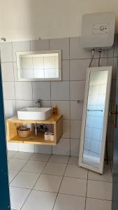 a bathroom with a sink and a mirror at Kaia Beach House Boa Vista Front Sea View Apartments in Sal Rei
