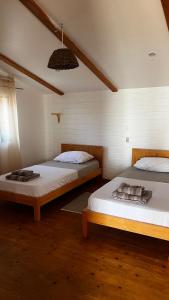 two beds sitting in a room with at Kaia Beach House Boa Vista Front Sea View Apartments in Sal Rei