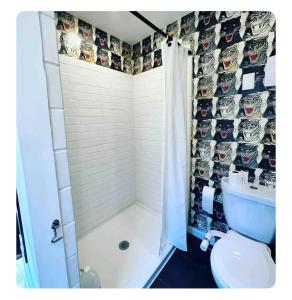 a bathroom with a shower and a toilet with a shower curtain at Nomehaus shipping container studio residential neighborhood ATHENS in Athens +13 photos