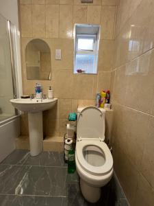 a bathroom with a toilet and a sink at Silk Accommodation in Margate