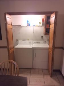 a kitchen with a sink and a dishwasher at Oakhaven in Long Beach