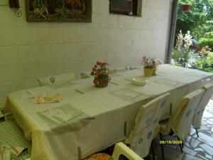 a table with a white table cloth and flowers on it at Villa Trakia in Golden Sands