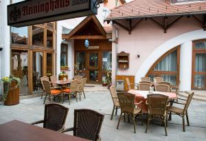 a restaurant with tables and chairs in front of a building at Hotel Wagner in Szombathely
