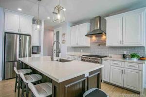 a kitchen with white cabinets and a white counter top at Cheerful 3-bedroom Residential home with Pool in Mission