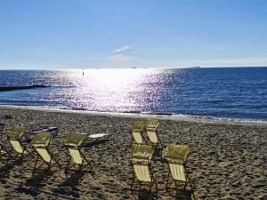 a group of chairs sitting on a beach at Fernhurst holiday apartments in Shanklin