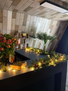 a room with flowers and lights on a counter at ИксаОтель in Shymkent
