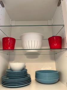 a shelf with bowls and plates in a kitchen at Suite Lady Marian in Roccaraso