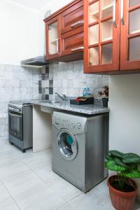 a kitchen with a washing machine and a counter at Lazur Hotel Apartments in Hurghada