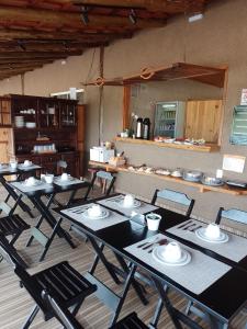 a group of tables and chairs in a room at pousada solar da canastra in Delfinópolis