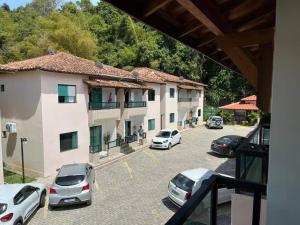 a group of cars parked in a parking lot at Apartamento mobiliado in Porto Seguro