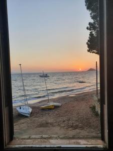 a view of a beach with two boats on the shore at Beach house in Cavo