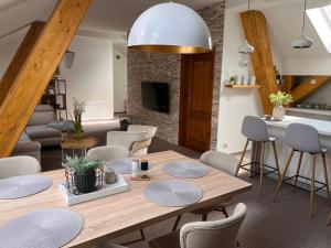 een keuken en een woonkamer met een houten tafel en stoelen bij Vila Kollár in Vysoké Tatry