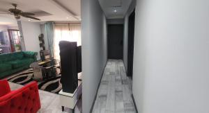 a living room with a couch and a flat screen tv at Jo's Eden in Edenvale