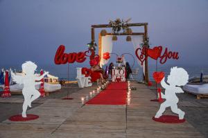 an entrance to a wedding on the beach with love signs at LARA BOUTIQUE HOTEL Antalya in Lara