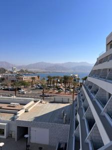 a view of a building and a body of water at סויטה מול הים סיסייד in Eilat