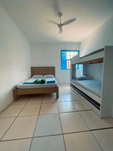a bedroom with two bunk beds and a tiled floor at Hospedagem Riccetti´s - Consulado Americano in Sao Paulo