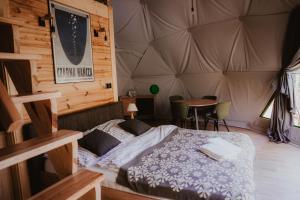 a bedroom with a bed in a tent at Czarna Hańcza Glamping in Głęboki Bród