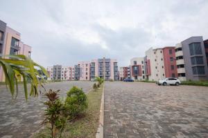 a parking lot in a city with buildings at 1 Bedroom Lake View Apartment in Entebbe