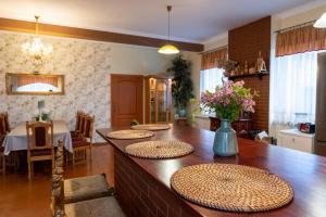 a dining room with a table with a vase of flowers at Agroturystyka Ranczo in Wünschelburg