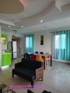 a living room with a couch and a table at Résidence Ahitantsoa Appartement à l'étage in Mahajanga