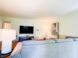 a living room with a couch and a flat screen tv at Family-Friendly 2BR in Quiet Area -AM1 in Los Angeles