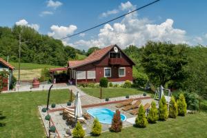 a house with a swimming pool in the yard at Holiday House Sunny Hill in Veliko Trgovišće