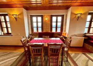 a dining room with a table and chairs at Βίτσα Πετρόκτιστο Αρχοντικό "Ιόλη" με θέα Ζαγόρι in Vitsa +116 photos