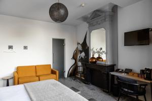 a bedroom with a bed and a desk and a mirror at Boutique Hotel View in Amsterdam