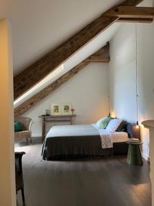 a bedroom with a large bed in a attic at La Grande Maurague in Condom
