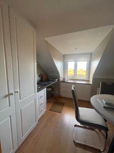 an attic room with a table and a window at Breezy Point Guesthouse in Donegal