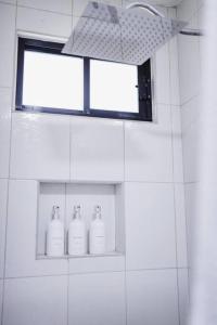 een badkamer met drie zeepflessen op een raam bij Casa Amma - Amma in Matehuala