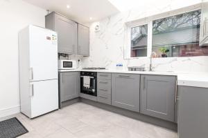 a kitchen with white appliances and a white refrigerator at Holiday Lodge, close to Nottingham City Centre in Nottingham