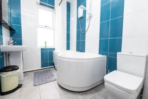 a blue and white bathroom with a toilet and a sink at Holiday Lodge, close to Nottingham City Centre in Nottingham