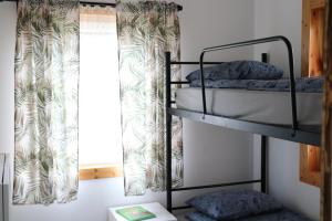 two bunk beds in a room with a window at Domki Bukowy Las in Rewa