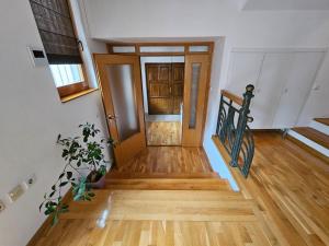 an empty hallway with wooden floors and a staircase at Villa Anni in Sarajevo