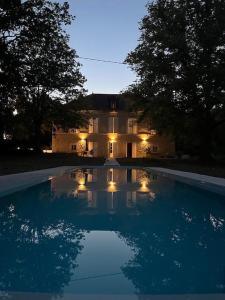 a large swimming pool in front of a house at La Grande Maurague in Condom