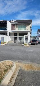 a car parked in front of a white building at AKMA HOMES DESARU in Bandar Penawar