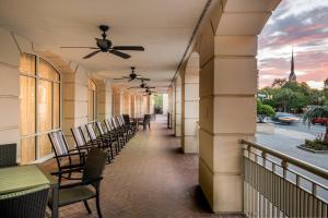 a balcony with chairs and a ceiling fan on a building at Courtyard by Marriott Charleston Historic District in Charleston