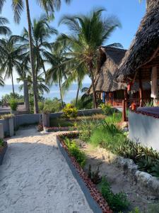 a resort on the beach with palm trees at Mafia Beach Bungalows sea view in Utende